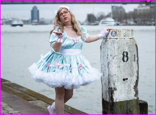 Sissy maid Olivia forced to pose outside in degrading frilly frock